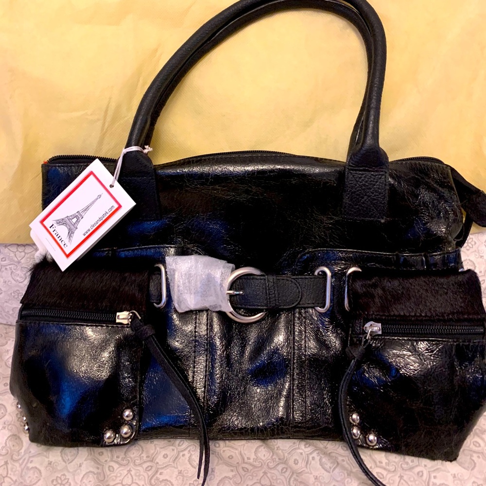 NWT. Genuine leather bag with pony fur pockets.